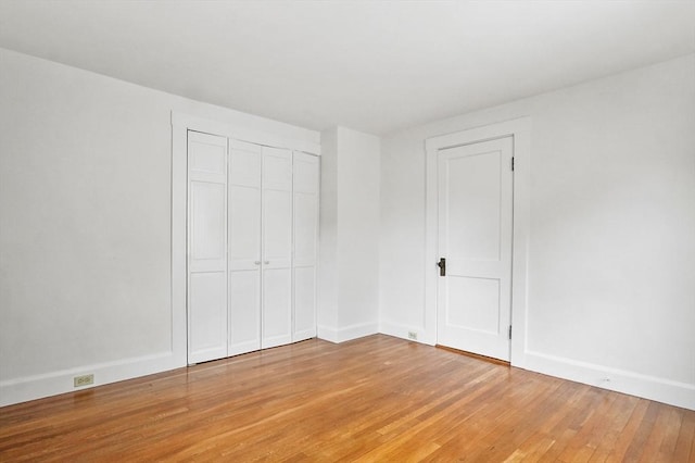 14 Lyman Ter, Waltham, MA 02452 - unfurnished bedroom featuring light wood-style flooring, a closet, and baseboards