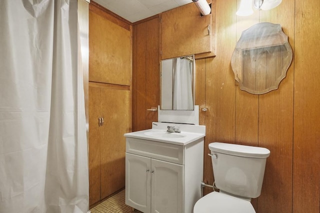 14 Lyman Ter, Waltham, MA 02452 - bathroom with vanity, wood walls, toilet, and a shower with curtain