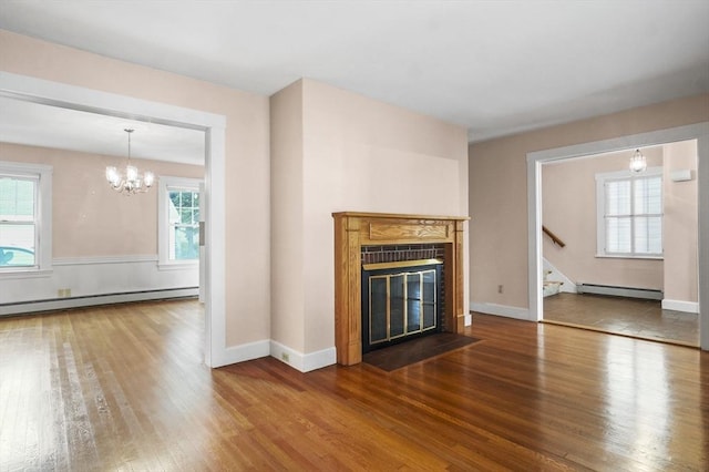 14 Lyman Ter, Waltham, MA 02452 - unfurnished living room with baseboard heating, wood finished floors, a fireplace with flush hearth, and stairway