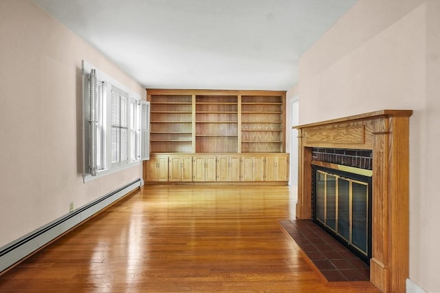 14 Lyman Ter, Waltham, MA 02452 - unfurnished living room featuring baseboard heating, a fireplace, and dark wood-style floors