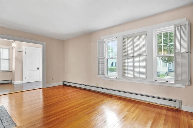14 Lyman Ter, Waltham, MA 02452 - unfurnished room featuring a baseboard radiator, healthy amount of natural light, and wood finished floors
