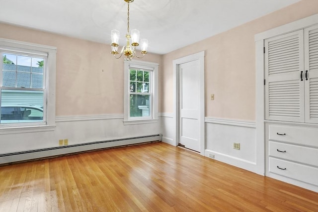 14 Lyman Ter, Waltham, MA 02452 - unfurnished dining area with light wood-style flooring, a chandelier, and baseboard heating