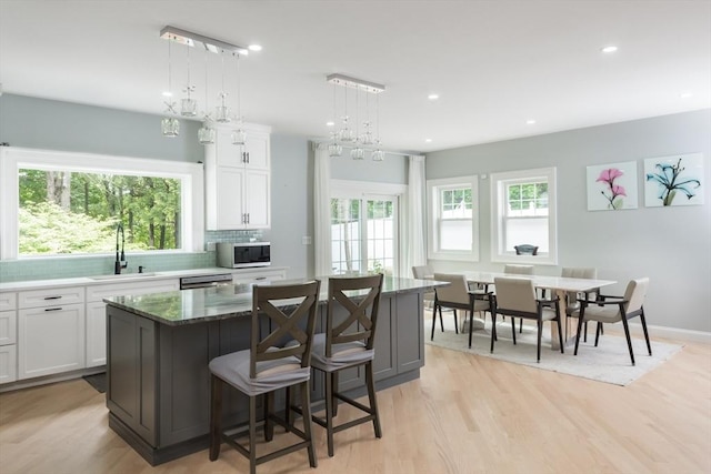 6 Fallon Cir, Braintree, MA 02184 - kitchen featuring a sink, a kitchen island, decorative backsplash, white cabinets, and recessed lighting