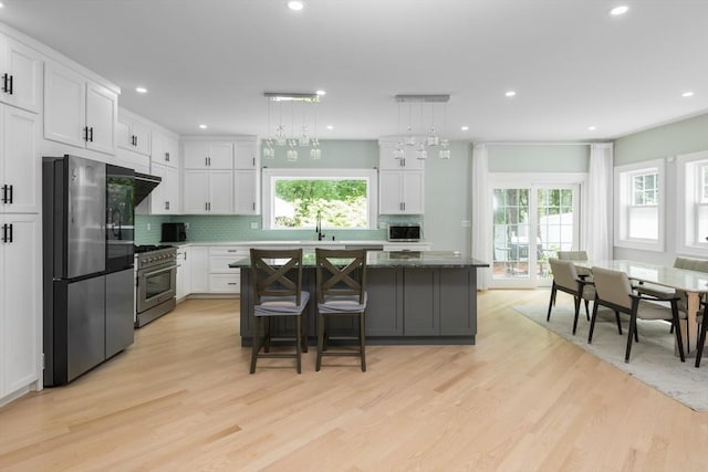 6 Fallon Cir, Braintree, MA 02184 - kitchen with appliances with stainless steel finishes, a kitchen island, white cabinets, light wood-style floors, and recessed lighting