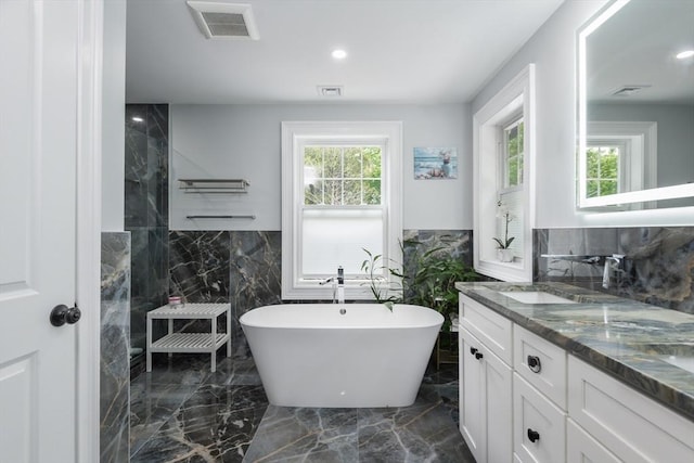 6 Fallon Cir, Braintree, MA 02184 - bathroom with double vanity, a freestanding tub, marble tiled flooring, walk in shower, and tile walls