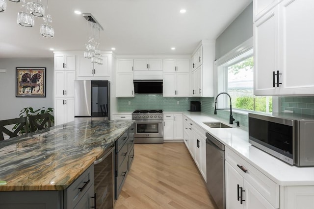 6 Fallon Cir, Braintree, MA 02184 - kitchen with stainless steel appliances, a sink, wine cooler, range hood, and backsplash