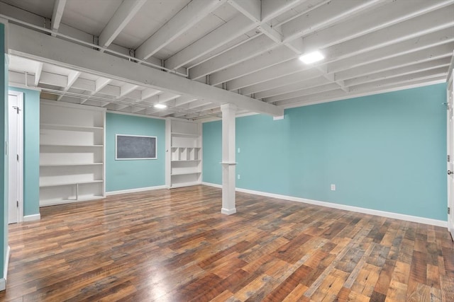 finished basement with hardwood / wood-style flooring and baseboards