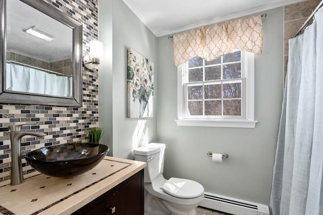 bathroom featuring crown molding, tasteful backsplash, toilet, baseboard heating, and vanity