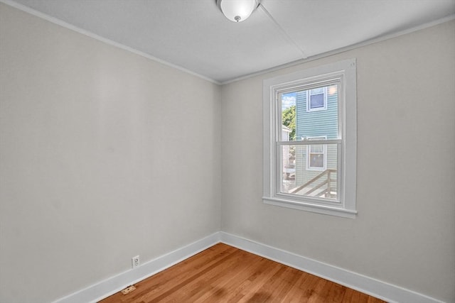 empty room featuring light wood finished floors and baseboards