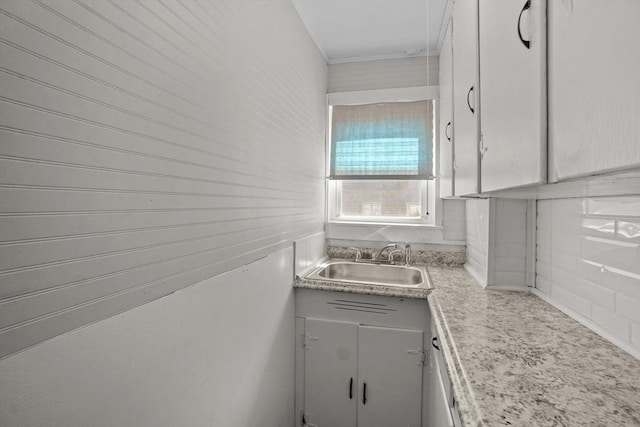 kitchen featuring light countertops and a sink