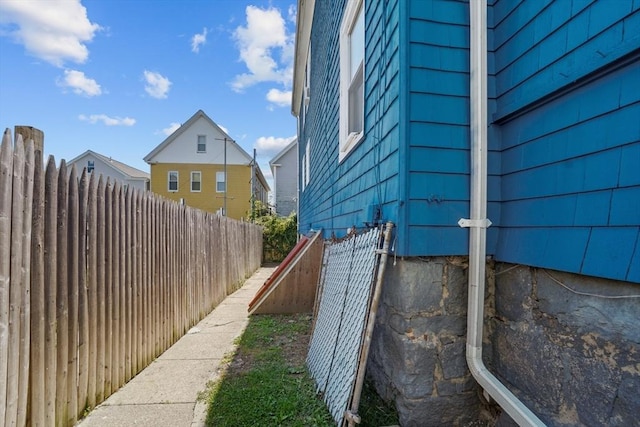 view of side of home featuring fence