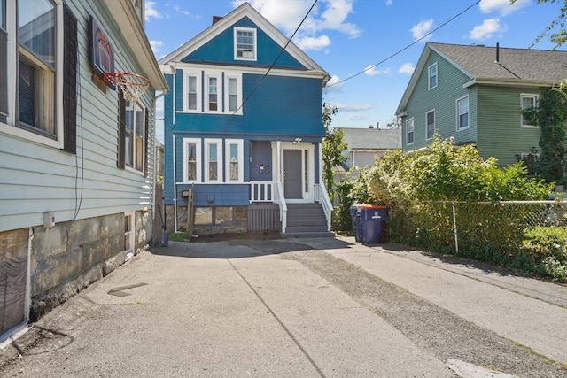 american foursquare style home with fence