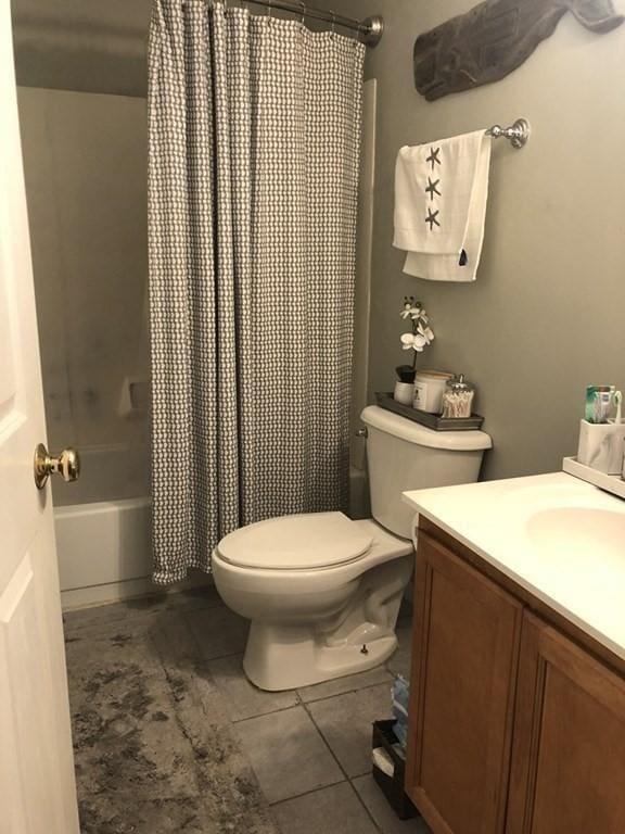 full bathroom featuring tile patterned floors, vanity, toilet, and shower / tub combo with curtain