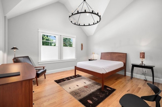 bedroom with a chandelier, high vaulted ceiling, and light wood-type flooring