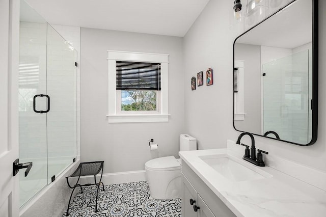 full bathroom featuring tile patterned flooring, vanity, combined bath / shower with glass door, and toilet