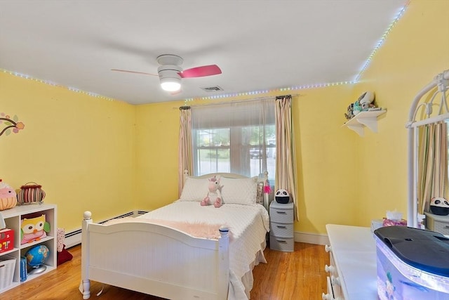 34 Woodland Cir, Methuen, MA 01844 - bedroom with wood finished floors, a ceiling fan, baseboards, and a baseboard radiator