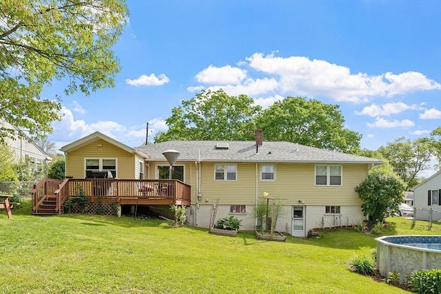 34 Woodland Cir, Methuen, MA 01844 - rear view of property featuring a wooden deck, a yard, and a chimney