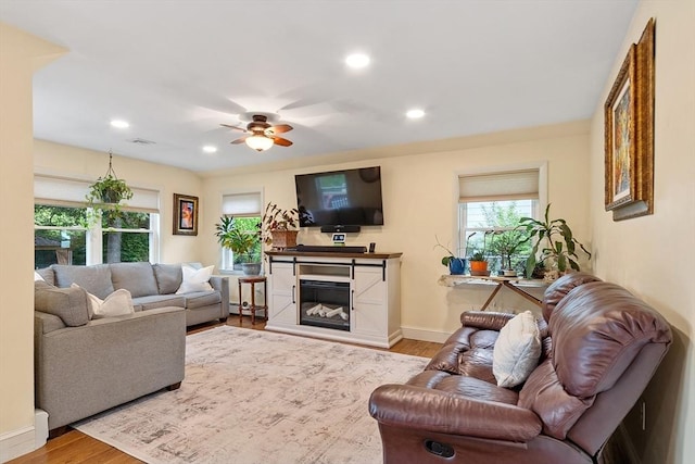 34 Woodland Cir, Methuen, MA 01844 - living area with wood finished floors, ceiling fan, baseboards, recessed lighting, and a glass covered fireplace