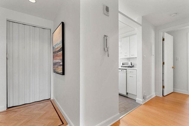 931 Massachusetts Ave Unit 606, Cambridge, MA 02139 - hallway featuring baseboards and light wood finished floors