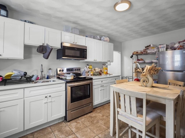 15-17 W Chestnut St, Brockton, MA 02301 - kitchen featuring appliances with stainless steel finishes, white cabinetry, and light countertops