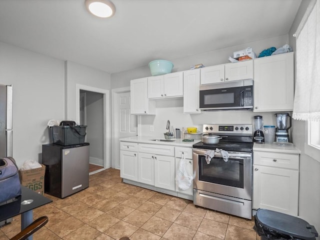 15-17 W Chestnut St, Brockton, MA 02301 - kitchen featuring stainless steel appliances, light countertops, and white cabinetry