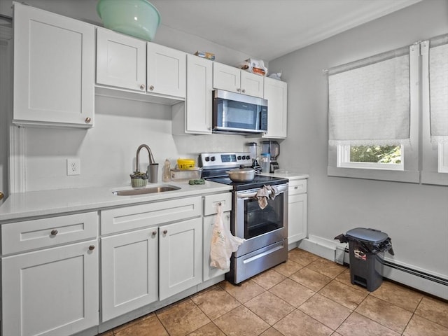 15-17 W Chestnut St, Brockton, MA 02301 - kitchen featuring stainless steel appliances, light countertops, white cabinets, light tile patterned flooring, and a baseboard radiator