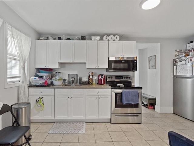15-17 W Chestnut St, Brockton, MA 02301 - kitchen with appliances with stainless steel finishes, white cabinets, and light tile patterned floors