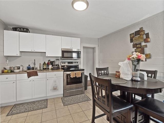 15-17 W Chestnut St, Brockton, MA 02301 - kitchen with appliances with stainless steel finishes, white cabinetry, and light tile patterned floors