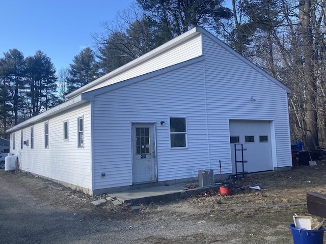 back of property with a garage