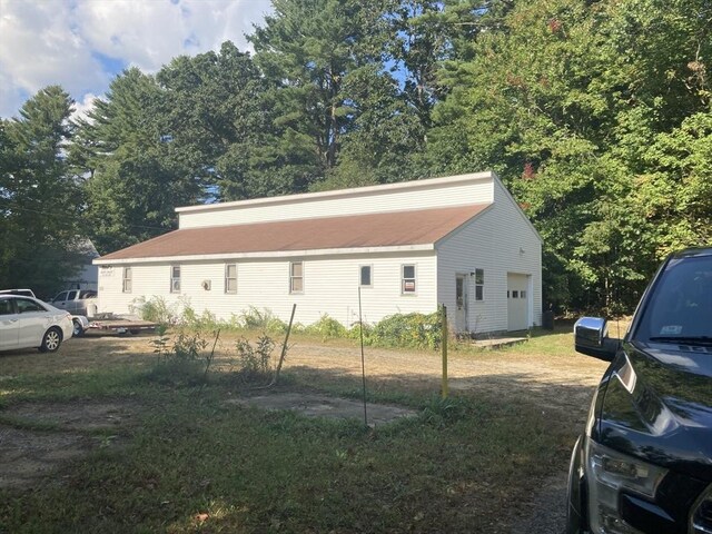 view of home's exterior with a detached garage
