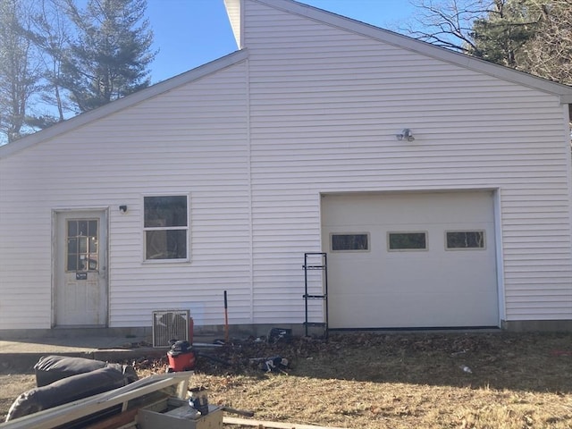 rear view of property featuring a garage