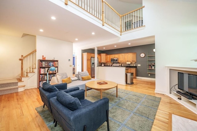 97 High Pine Cir Unit 97, Wilbraham, MA 01095 - living room featuring stairway, light wood finished floors, recessed lighting, and a high ceiling