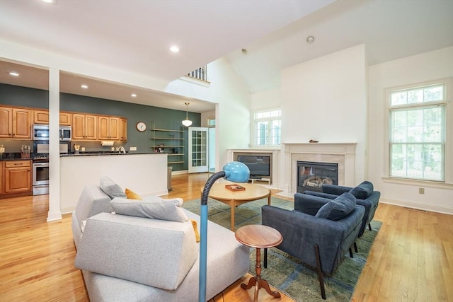 97 High Pine Cir Unit 97, Wilbraham, MA 01095 - living area featuring a fireplace, light wood-style flooring, recessed lighting, baseboards, and high vaulted ceiling