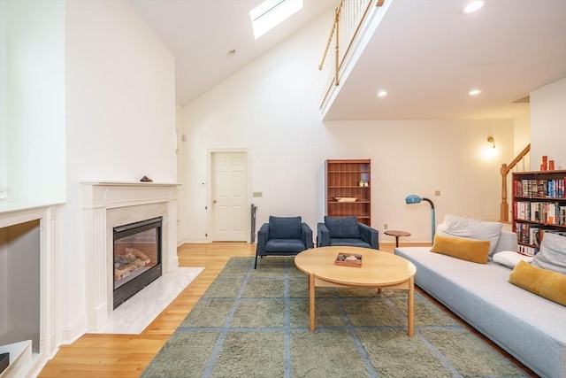 97 High Pine Cir Unit 97, Wilbraham, MA 01095 - living area with wood finished floors, a fireplace, recessed lighting, high vaulted ceiling, and a skylight