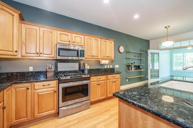 97 High Pine Cir Unit 97, Wilbraham, MA 01095 - kitchen with stainless steel appliances, a sink, light wood finished floors, dark stone countertops, and recessed lighting