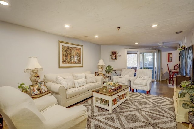 living room featuring ceiling fan and wood-type flooring