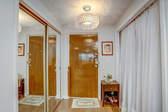 entryway featuring a chandelier and hardwood / wood-style flooring