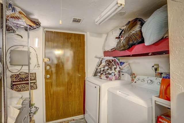 clothes washing area with independent washer and dryer