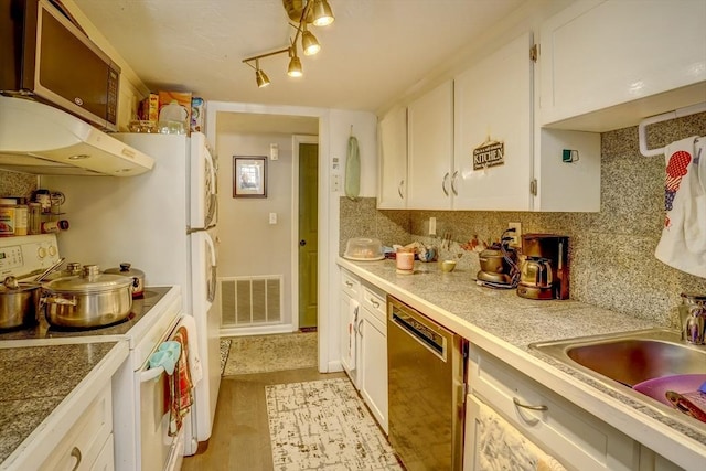 kitchen with stainless steel dishwasher, sink, electric stove, white cabinets, and light hardwood / wood-style floors