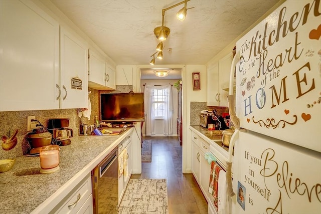 kitchen with white cabinetry, rail lighting, stainless steel dishwasher, backsplash, and hardwood / wood-style floors