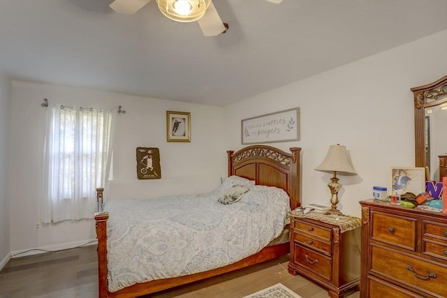 bedroom featuring hardwood / wood-style flooring and ceiling fan