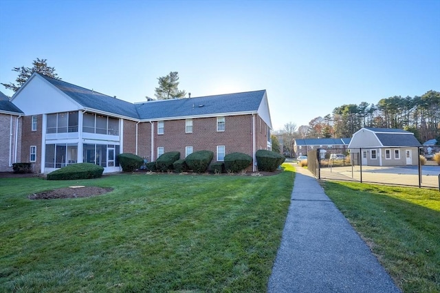 view of home's exterior with a lawn and an outbuilding