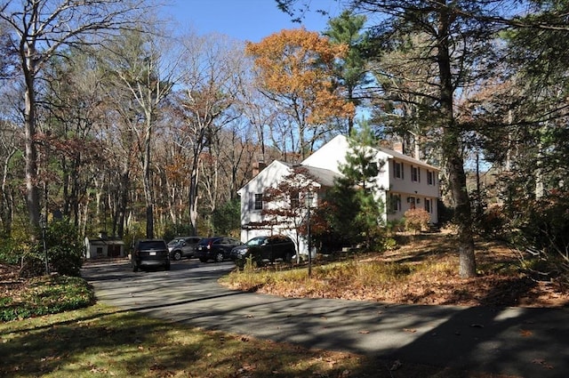 exterior space with driveway and a chimney