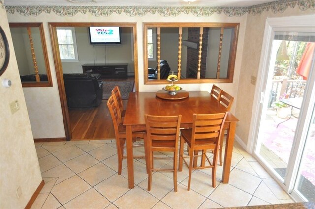 dining room featuring baseboards and light tile patterned floors