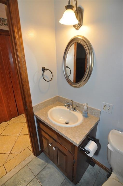 bathroom with vanity, toilet, and tile patterned floors