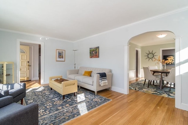 living room featuring crown molding and light hardwood / wood-style floors