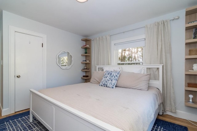 bedroom with dark hardwood / wood-style floors