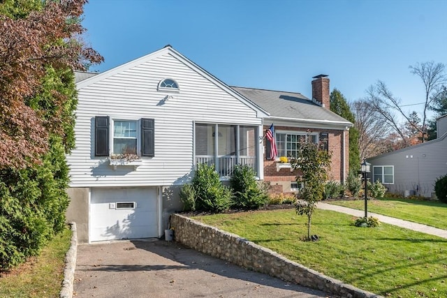 view of front of home featuring a garage and a front yard