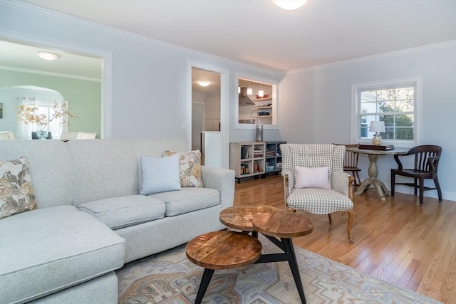 living room with crown molding and light hardwood / wood-style floors