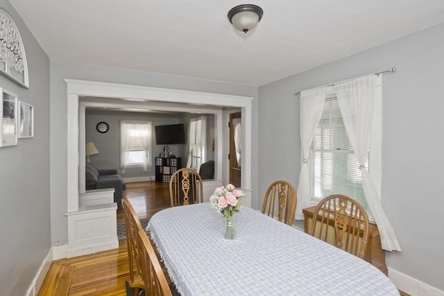 dining space featuring wood finished floors and baseboards